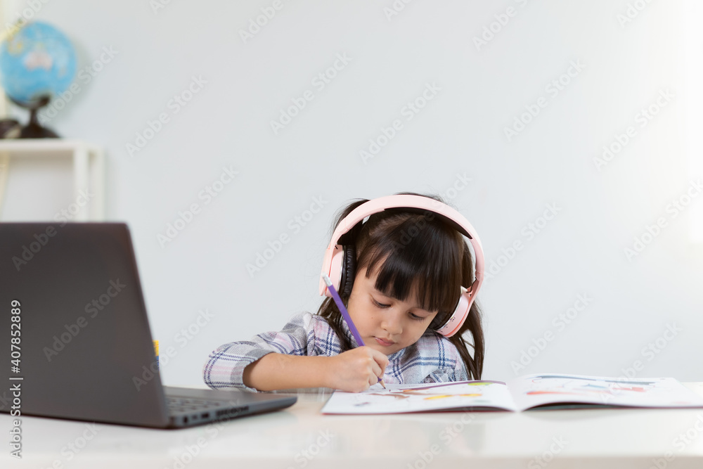 Asian girl student is happy learning online class at home , concept of online education and new normal of studying trend in the outbreak of corona virus. Asian girl student is happy learning online class at home , concept of online education and new normal of studying trend in the outbreak of corona virus.