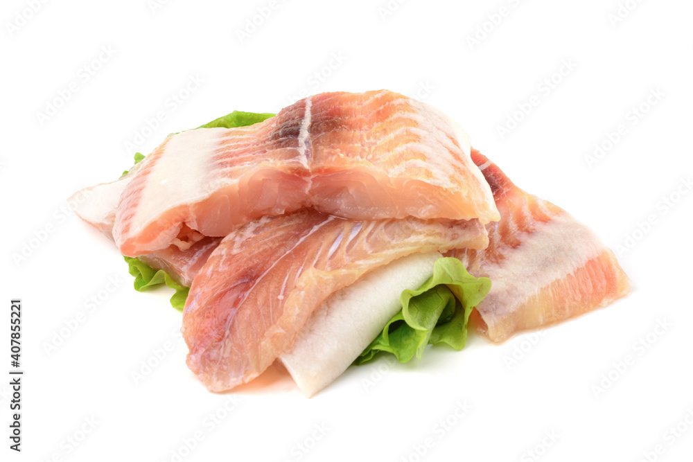 Pangasius fish fillet, pieces on a green lettuce leaf. Isolated on a white background. Fresh Fish Fillet. Pangasius fish fillet, pieces on a green lettuce leaf. Isolated on a white background. Fresh Fish Fillet.