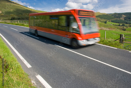 Red bus on rural road