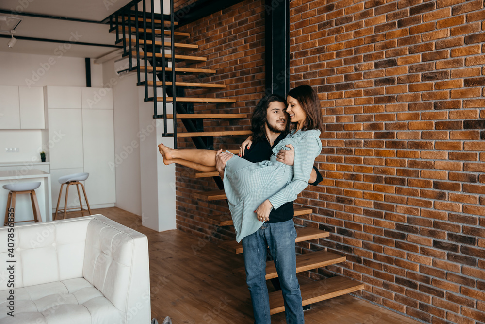 Husband holds his beloved wife in his arms Husband holds his beloved wife in his arms