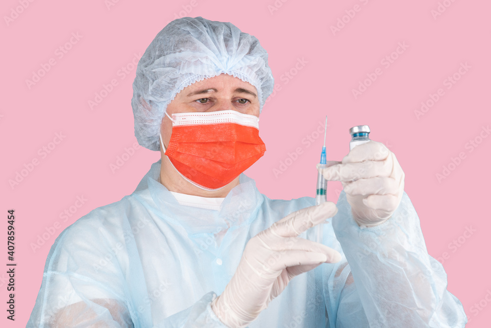 doctor in medical mask holds syringe isolated on gray background. medical worker in protective suit, cap and surgical rubber gloves. Vaccine from, flu, coronavirus. mass vaccination of the population