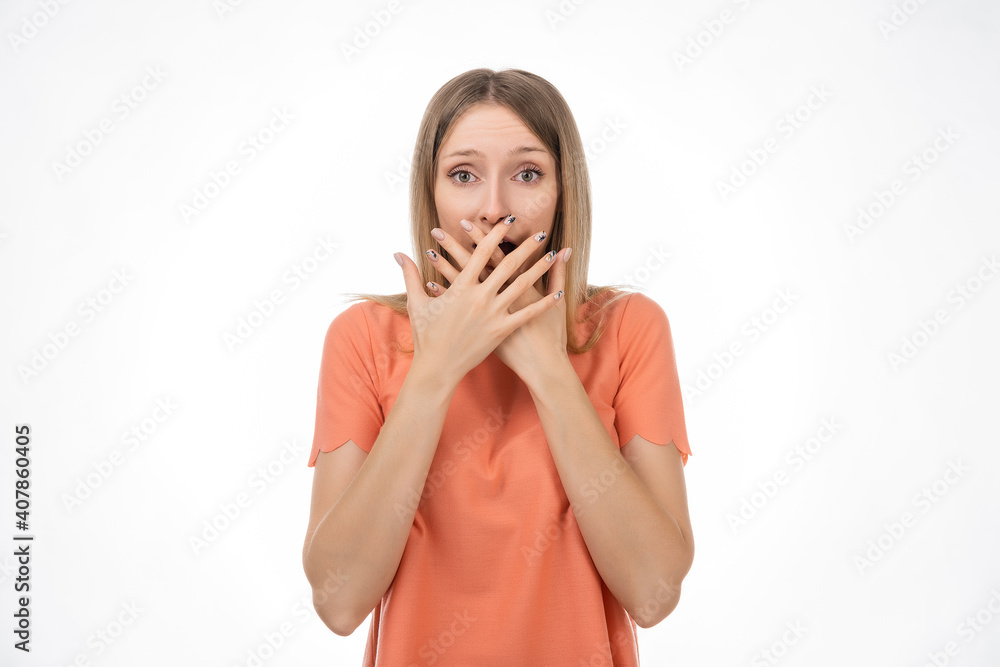 Worried blond girlcover opened mouth palm and looking with surprised expression. Studio shot, white background Worried blond girlcover opened mouth palm and looking with surprised expression. Studio shot, white background