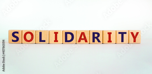 Time to solidarity symbol. Concept word solidarity on wooden cubes on a beautiful white background. White table. Business and solidarity concept. Copy space.