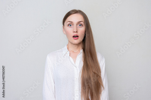 Wallpaper Mural Portrait of a surprised woman looking at the camera with her eyes wide open, white background Torontodigital.ca