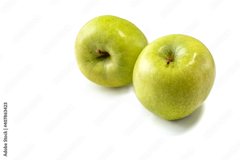 Green Granny Smith apples on a white isolated background.