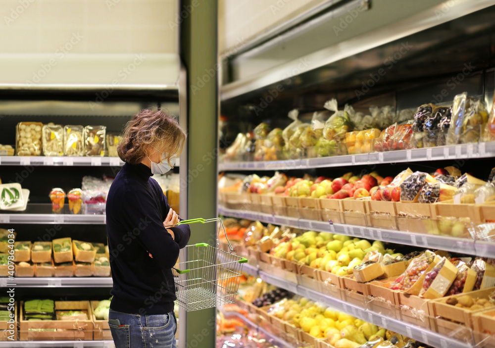 Supermarket shopping, face mask and gloves,man buying vegetables at the market.