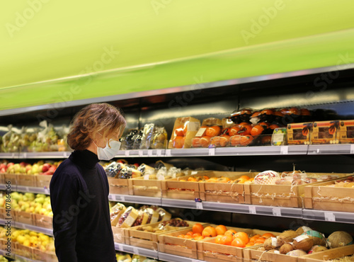 Supermarket shopping, face mask and gloves,man buying vegetables at the market.