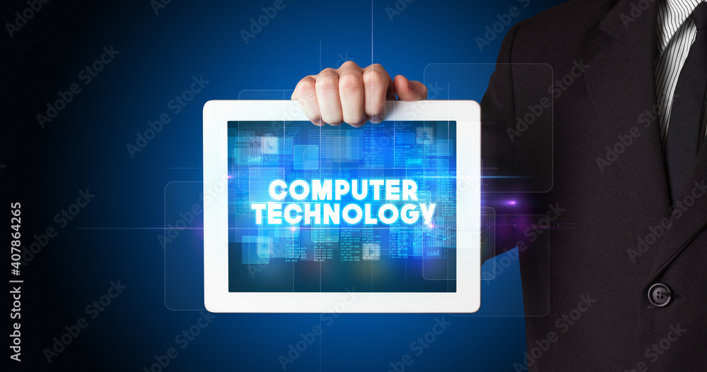 Young business person working on tablet and shows the inscription: COMPUTER TECHNOLOGY Young business person working on tablet and shows the inscription: COMPUTER TECHNOLOGY