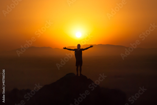 Vászonkép silhouette of a man watching the sunset