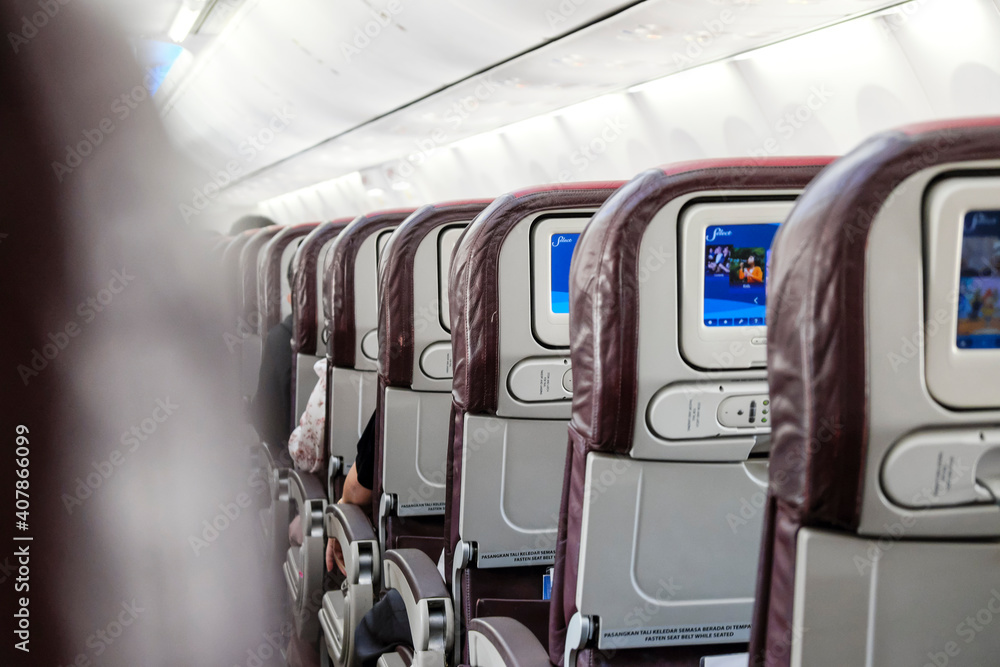 Fototapeta premium Rear view of an aircraft cabin seats.