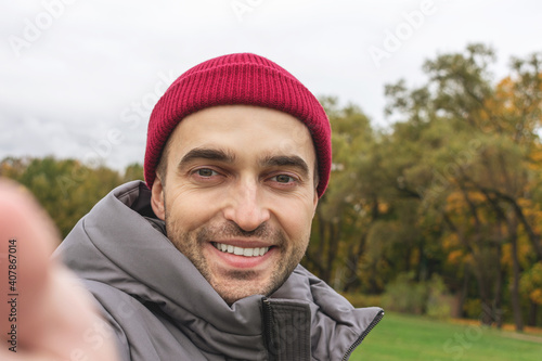 Attractive man takes a selfie in nature, portrait, closeup