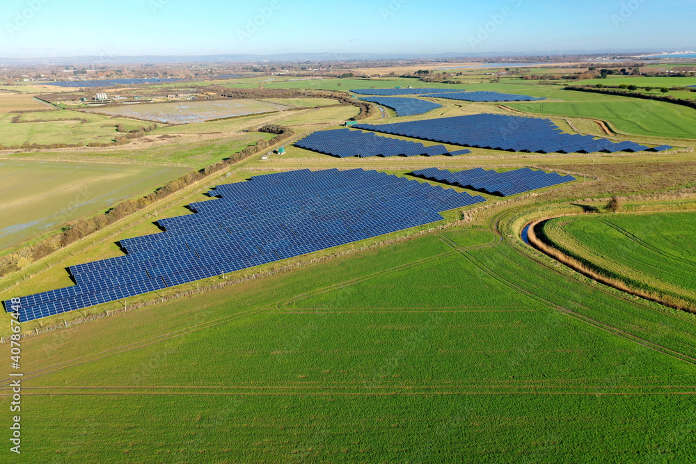 Aerial view of a solar panel farm in the beautiful countryside of Southern England.