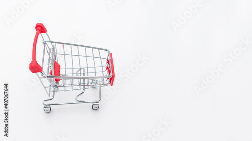 Shopping cart on a white background, top view, copy space, 16:9