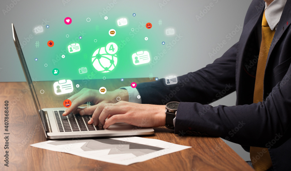 Hand surfing on the social media with notifications icons coming out from the screen, networking concept Hand surfing on the social media with notifications icons coming out from the screen, networking concept