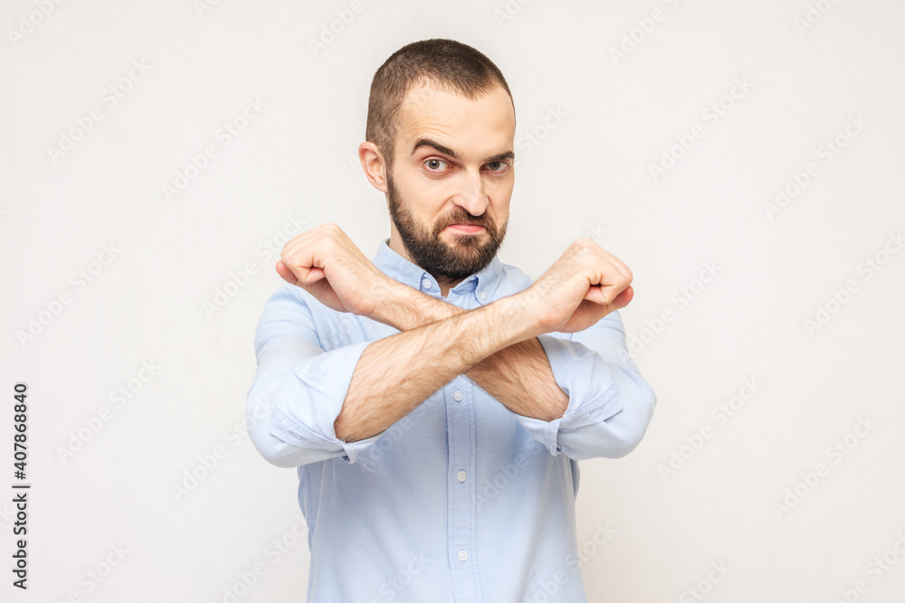 Brutal bearded man shows taboo gesture, white background Brutal bearded man shows taboo gesture, white background