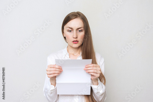 Wallpaper Mural Upset woman reading a letter, white background, copy space Torontodigital.ca