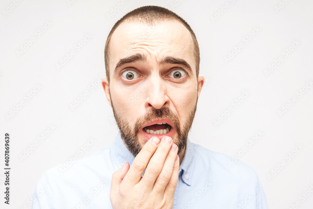 Bearded afraid, portrait of scared young man, white background, closeup Bearded afraid, portrait of scared young man, white background, closeup