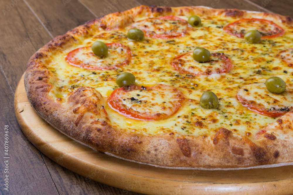 Mozzarella cheese pizza with slices of red tomatoes on a wooden board. Gastronomic photography. Mozzarella cheese pizza with slices of red tomatoes on a wooden board. Gastronomic photography.