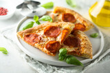 Traditional pepperoni pizza with fresh basil