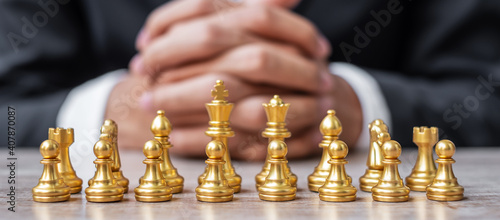 Gold Chess figure team (King, Queen, Bishop, Knight, Rook and Pawn) with businessman manager background. Strategy, Success, management, business planning, tactic, thinking, vision and leader concept