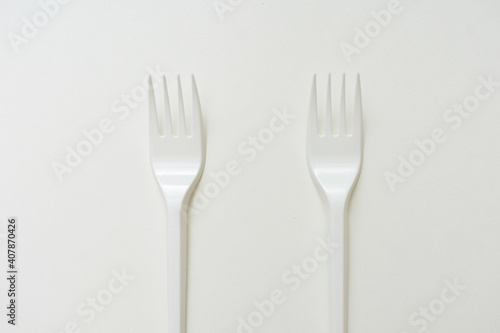 Top view of two plastic forks  white background  copy space