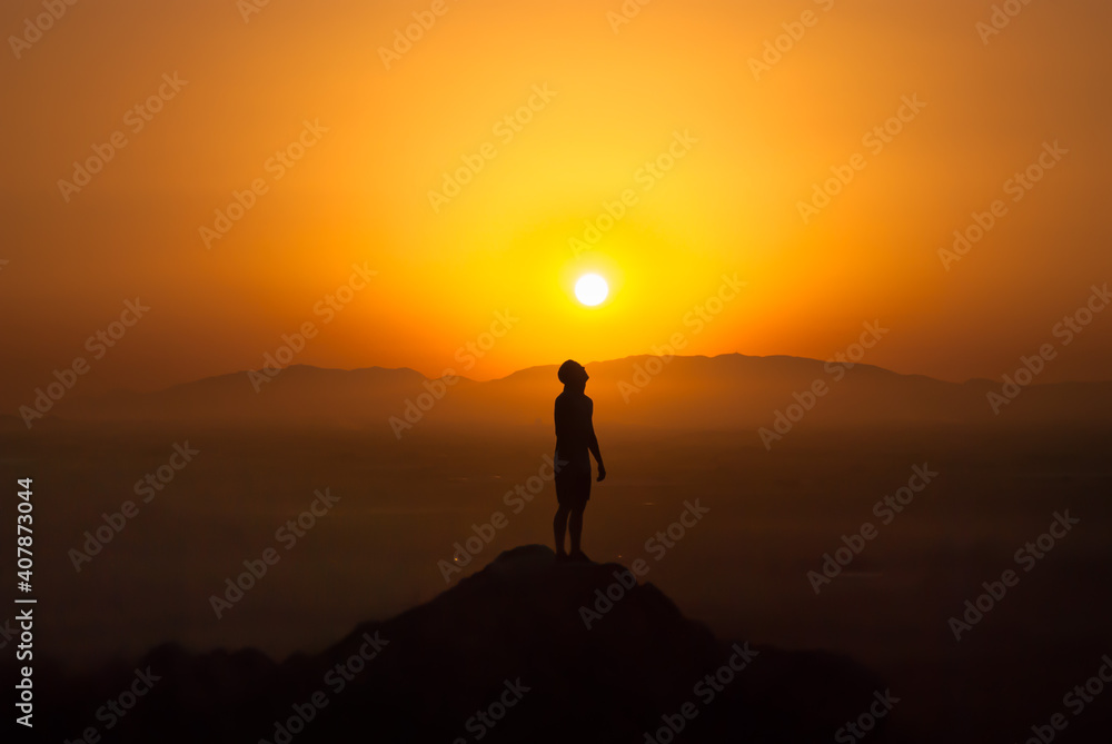 silhouette of a man looking sun