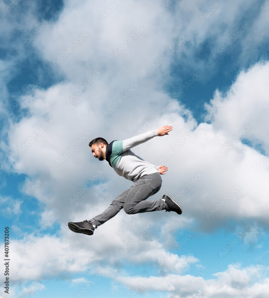 parkour jump in the air young and strong Caucasian boy outfit urban sport sweatshirt colors and blue sky free running street stun parkour jump in the air young and strong Caucasian boy outfit urban sport sweatshirt colors and blue sky free running street stun