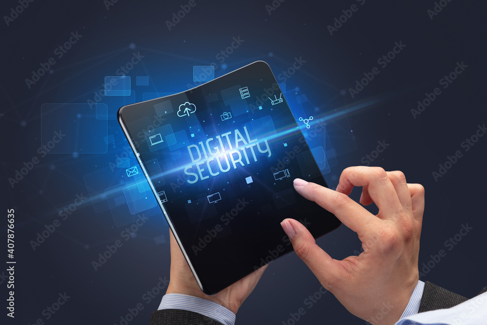 Businessman holding a foldable smartphone with DIGITAL SECURITY inscription, cyber security concept Businessman holding a foldable smartphone with DIGITAL SECURITY inscription, cyber security concept