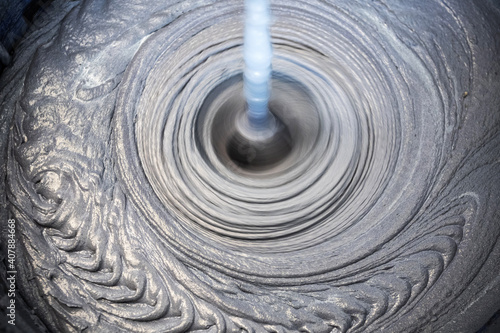 The process of mixing mortar with a perforator with a special nozzle photo