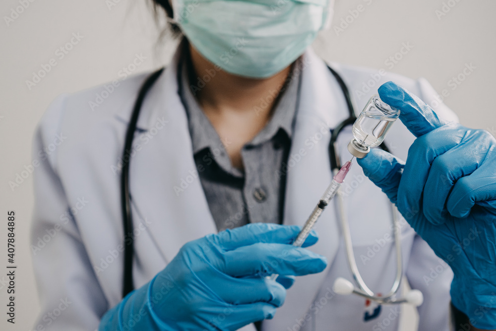 female doctor, scientist, researcher is showing syringe and vaccine vial with medication, closeup. Vaccination and immunization female doctor, scientist, researcher is showing syringe and vaccine vial with medication, closeup. Vaccination and immunization