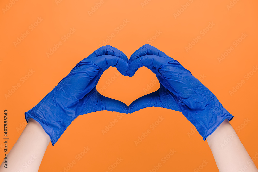 Male hands in medical protection latex gloves making heart symbol as a ...