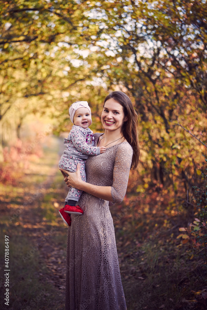 Close-up of little girl in her mother's arms in park