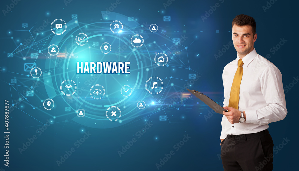Businessman thinking in front of technology related icons and HARDWARE inscription, modern technology concept Businessman thinking in front of technology related icons and HARDWARE inscription, modern technology concept