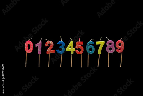 Set of colorful birthday candles on the black background Numbers 0-9.