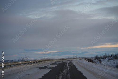 dawn on a winter road with clouds