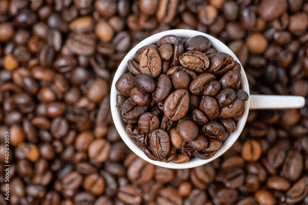 coffee beans close up and a cup full of coffee beans, top view coffee beans close up and a cup full of coffee beans, top view