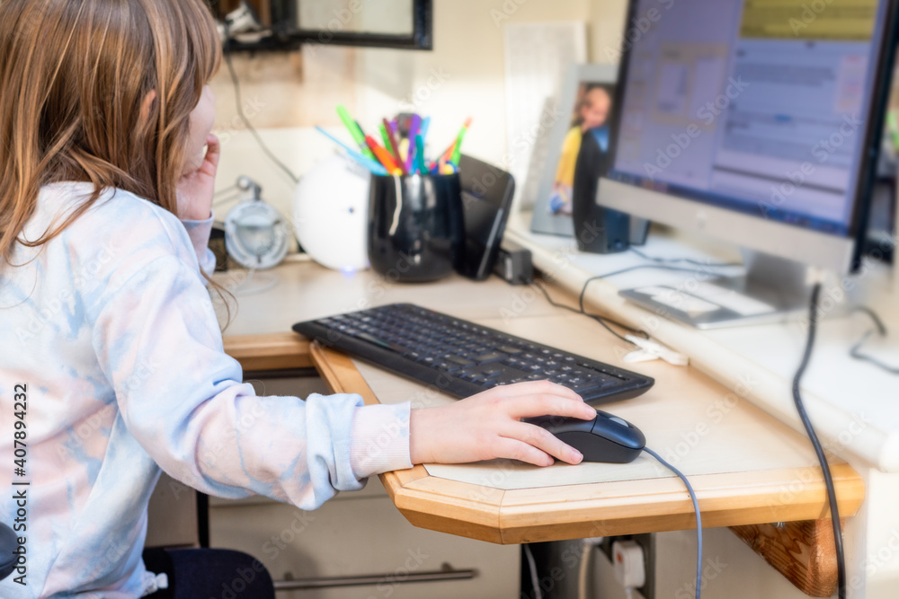 Child working at home during lockdown as children need to home school via online learning Child working at home during lockdown as children need to home school via online learning