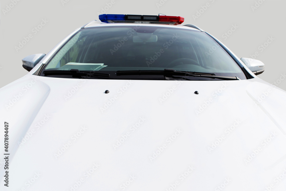 The hood of a white police car. Law enforcement vehicle with flashing beacons. Copy space. Selective focus