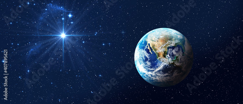 Planet Earth on dark blue night sky with bright star. Baner format. Christmas Star of Bethlehem Nativity, christmas of Jesus Christ. Elements of this image furnished by NASA © assistant