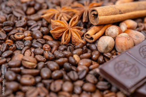 coffee beans close up, top view cinnamon, hazelnuts and chocolate, background image