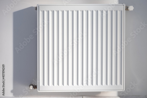 Wallpaper Mural A steel panel heating radiator is placed on a white wall. Torontodigital.ca