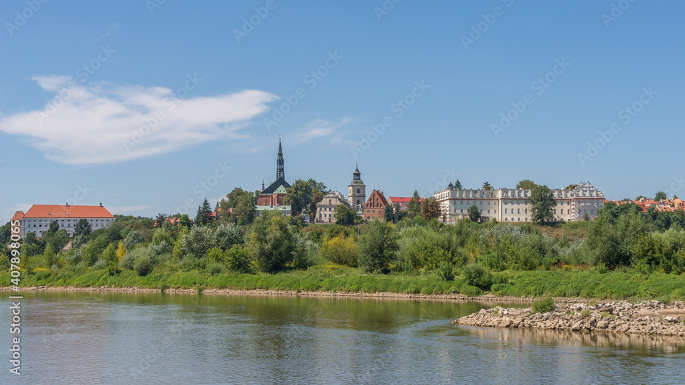 Skyline of the historical royal city on the bank of the Vistula river - panoramic view from riverboat cruise, Sandomierz, Poland