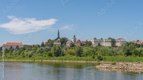 Skyline of the historical royal city on the bank of the Vistula river - panoramic view from riverboat cruise, Sandomierz, Poland © Damian Pawlos