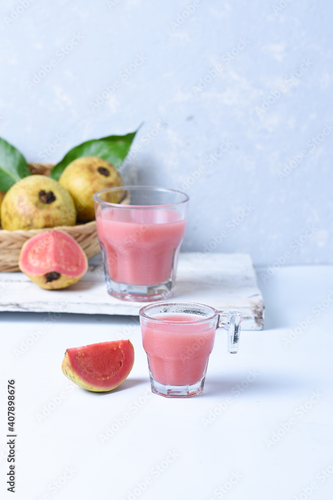 Glass of Guava Smoothie or juice with sliced fresh Guava fruit isolated on white background. Glass of Guava Smoothie or juice with sliced fresh Guava fruit isolated on white background.