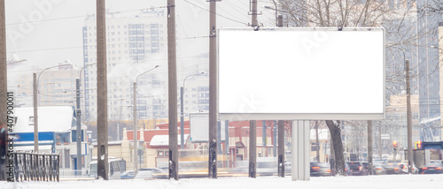 billboard in winter .MOCKUP with white advertising space near the road