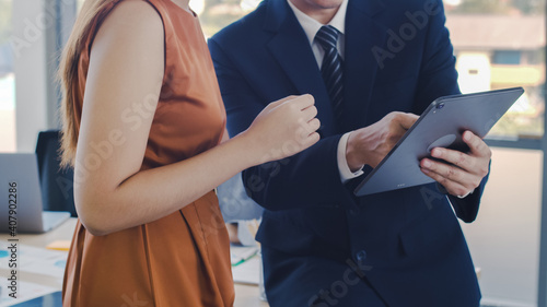 Exclusive manager showing plan project to a creative businesswoman in the modern office, businessman, and businesswoman discussion data analysis statistic infographic at the meeting room.