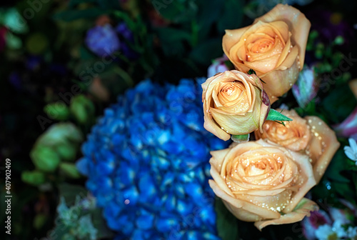 Close-up of a mixed bouquet of roses summer flowers background.