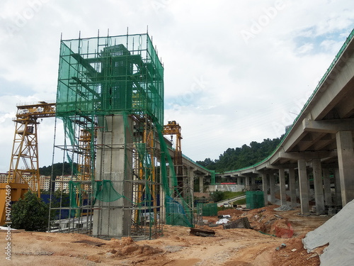 PENANG, MALAYSIA - MARCH 21, 2020: Overhead road under construction. The massive concrete column used to support the concrete road deck. Construction work is in full swing. photo