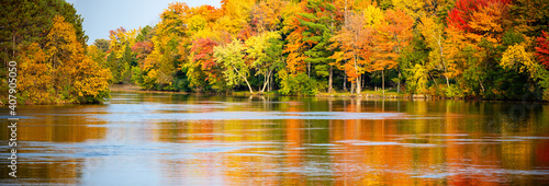 Colorful autumn trees reflecting off of the Wisconsin River in Merrill, Wisconsin photo