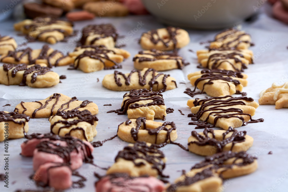 Pouring chocolate on just baked christmas cookies Pouring chocolate on just baked christmas cookies